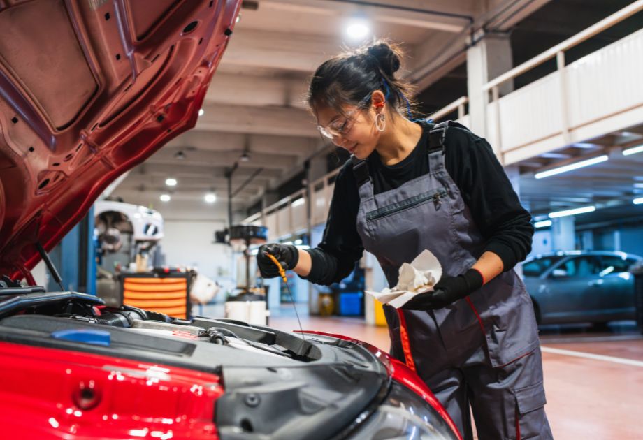woman checking oil in car